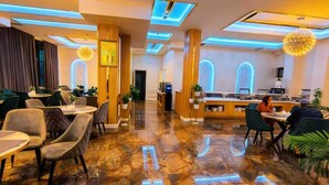 A hotel lobby with a marble floor, modern lighting, and a reception desk. - BlueShore International hotel (Tashkent)