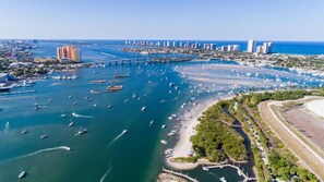 An aerial view of a coastal city with a marina, boats, and a bridge connecting two areas. - Newly Constructed Home near Downtown and Beaches (West Palm Beach)