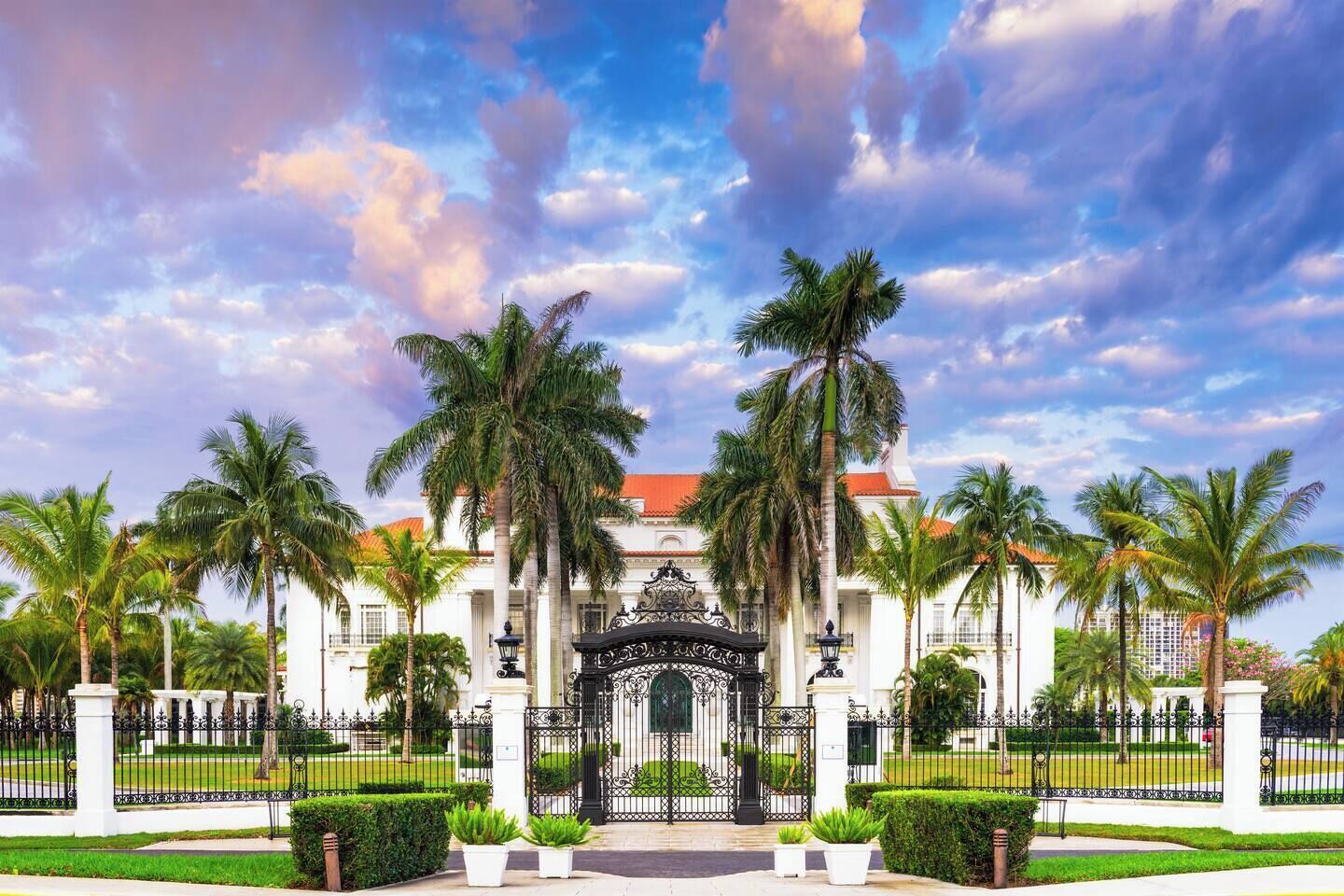 A grand building with a symmetrical facade, large windows, and a central entrance gate.