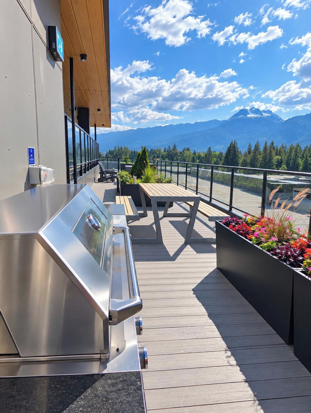An outdoor deck with a grill, seating, and a view of mountains.