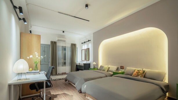 A modern hotel room with a desk, two beds, a vanity, and a large illuminated wall. - Quiet Family 6BR Home/Large Balcony/Street View/5' to Train St/Free Laundry (Hà Nội)