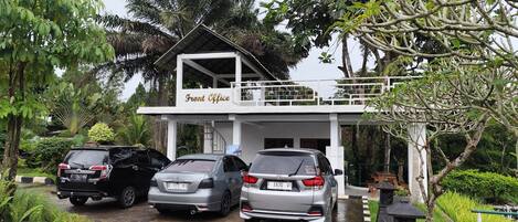 A building labeled "Front Office" with three parked cars in front.