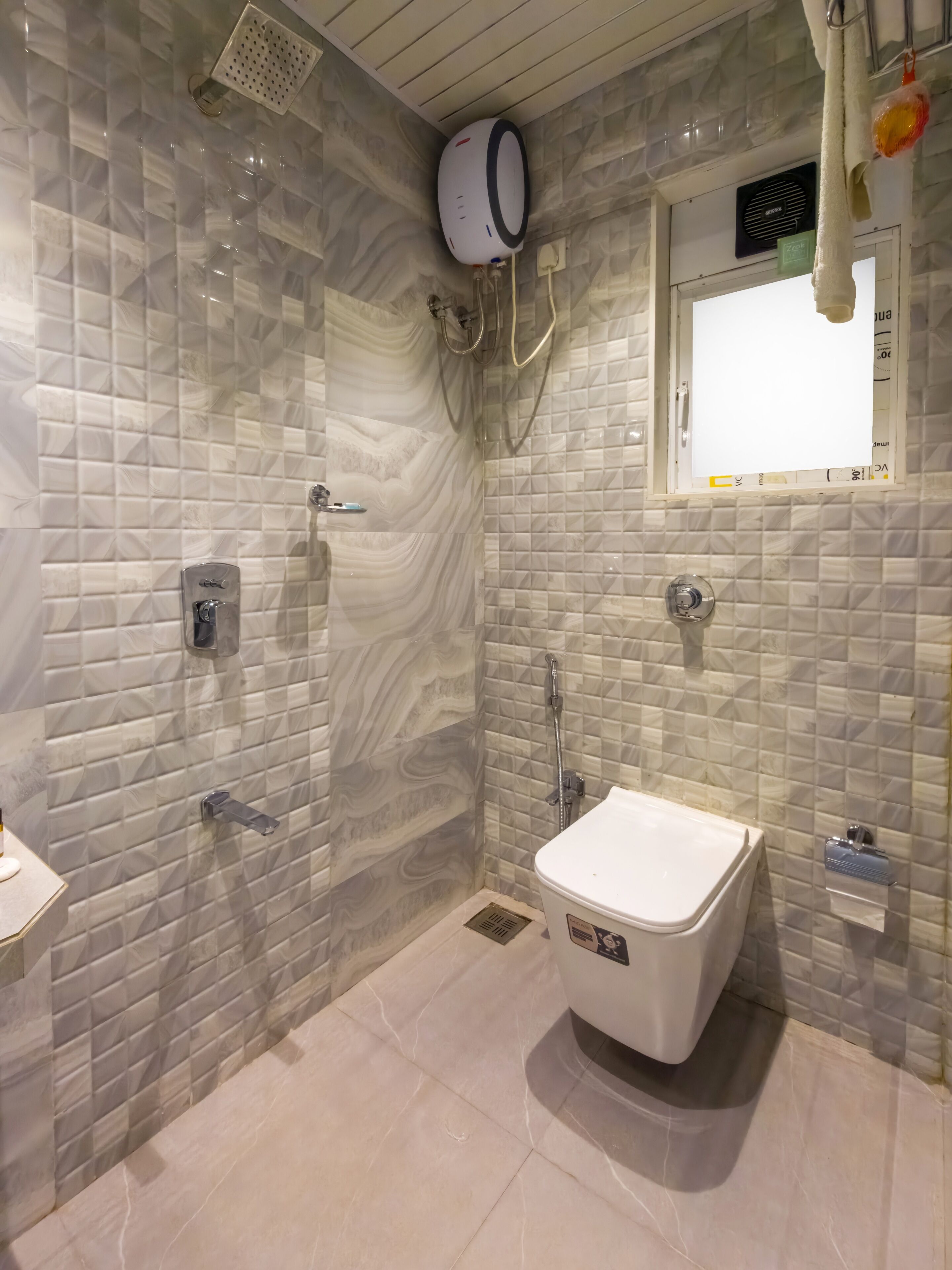 A bathroom with a shower, toilet, and a window.