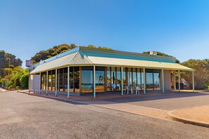 A building with a covered outdoor seating area and a sign indicating it is a beach hotel. - The Beach Hotel Whyalla (Whyalla)