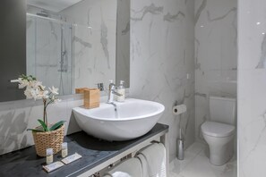 A bathroom with a large white sink, a mirror, a toilet, and a shower area. - Guestready - Bahl Apartments (Porto)