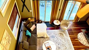 A spacious living area with a sofa, a coffee table, and a patterned rug.
