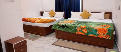 A hotel room with two beds, a wooden nightstand, a green bucket, and a marble floor.