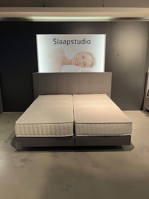 A bed with a headboard labeled 'Slaapstudio' and a mattress with a textured surface. - Modernized beach house in Kamperland Zeeland / Roompot Beach Resort-Landahl (Kamperland)