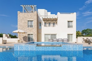 A modern two-story building with a swimming pool in front. - Vesta - Luxury Villa - 4BR - Joubal II (El Gouna)
