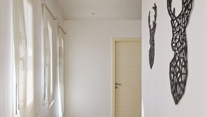 A hallway with a wooden floor, white walls, and a door at the end. - Vesta - Luxury Villa - 4BR - Joubal II (El Gouna)