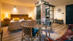A hotel room with a bed, a glass table, wicker chairs, a sofa, and a wardrobe. - Turkusowa Wyspa (Wlen)