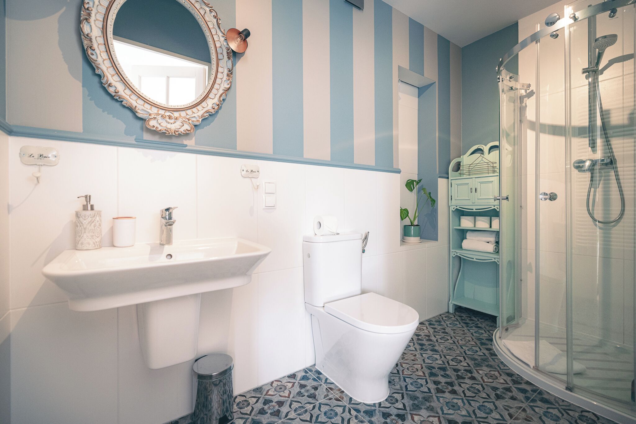 A bathroom with a toilet, sink, and shower.