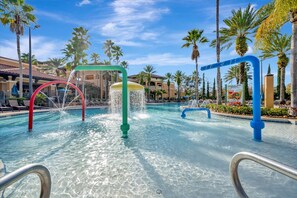 A swimming pool with water features, surrounded by palm trees and hotel buildings. - Free Breakfast Parking 2B Disney Resort Condo (Orlando)