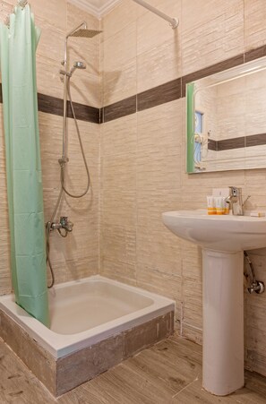 A bathroom with a shower, a sink, and a mirror. - Vesta - Luxury APT - 2BR - Zayed Dunes (Sheikh Zayed City)