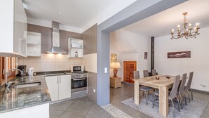 A modern kitchen with a built-in oven, microwave, and stainless steel range hood. - Beautiful Home in the Heart of Mallorca with Air Conditioning and Wi-Fi (Petra)