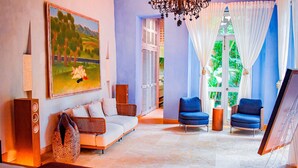 A spacious living area with a sofa, two armchairs, a painting, and a chandelier. - NOK Private Villa in Cartagena s Walled City (Cartagena)