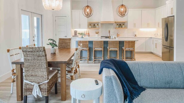 A modern kitchen with white cabinets, a central island, and pendant lighting. - Pearl House - Heated Pool & Hot Tub, Sleeps 20! (South Padre Island)