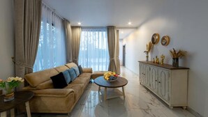 A living room with a sofa, coffee table, and a cabinet.