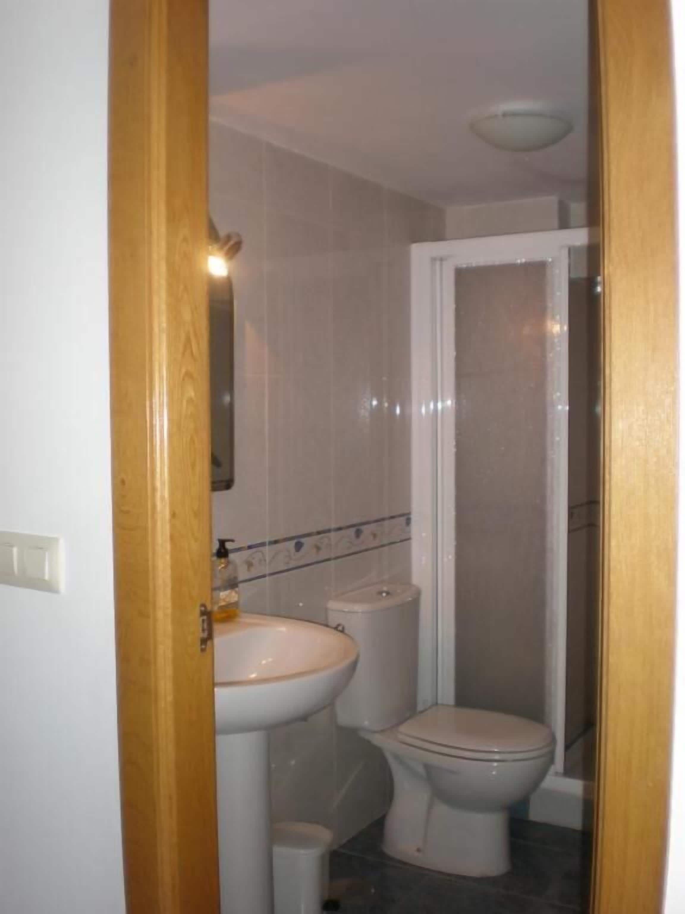 A bathroom with a sink, toilet, and shower.
