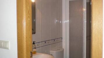 A bathroom with a sink, toilet, and shower.