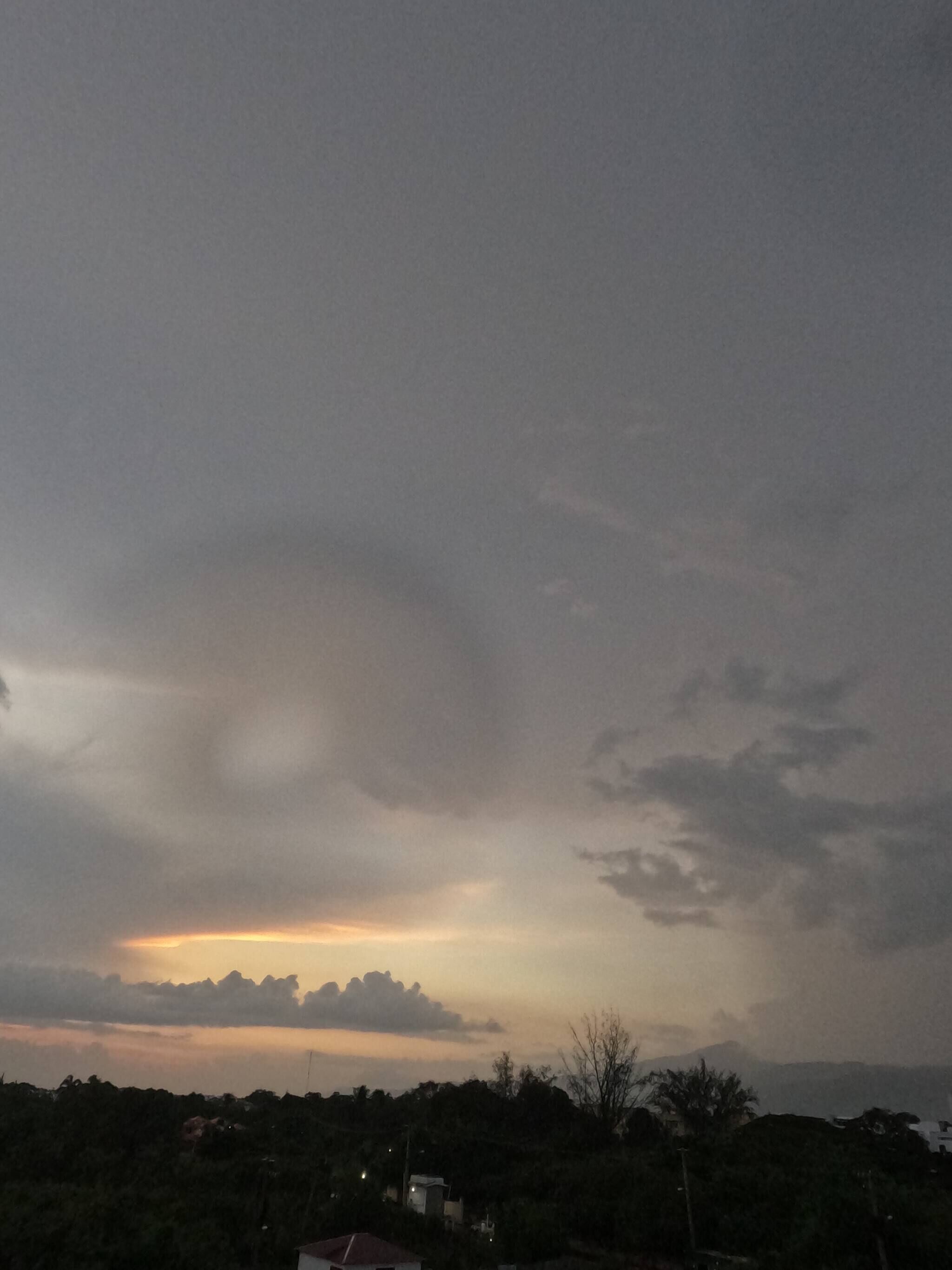 A cloudy sky with a faint sunset.