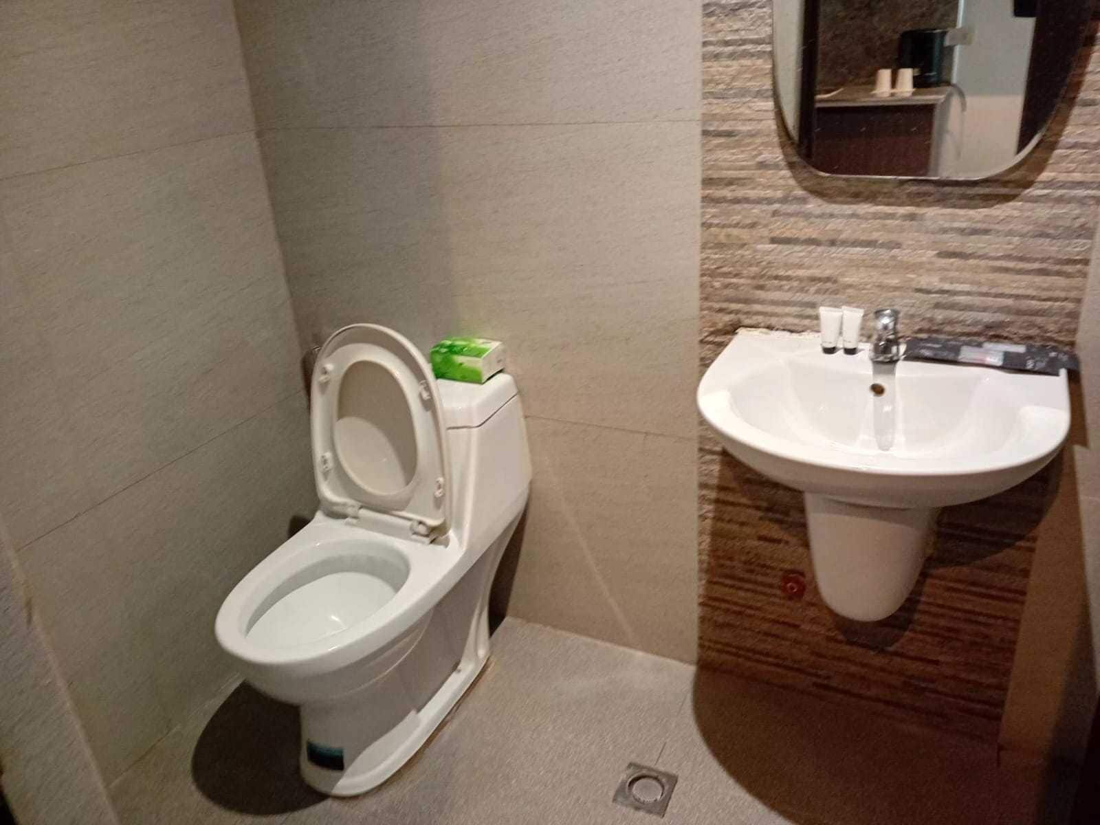 A modern bathroom with a toilet and a sink.