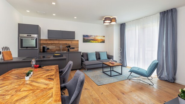 A modern living space with a kitchen, dining area, and seating area. - MyWinkl-Design-Ferienwohnungen  (Reit im Winkl)