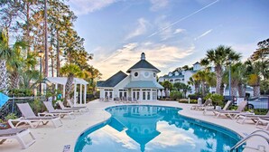 A pool area with lounge chairs and a building with a dome roof. - Golfers Paradise w/ Pool! 6 Mi to Myrtle Beach (Myrtle Beach)
