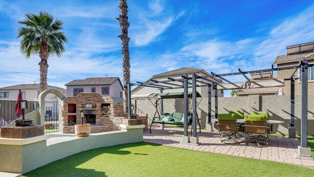A backyard with a barbecue area, outdoor furniture, and a pergola. - Heated Pool, Pets Welcome: Surprise Snowbird Haven (Surprise)