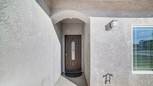 A house with a brown door, a small porch, and a window with blinds. - Fully Updated! Prime Riverside Spot Near Dtwn (Riverside)