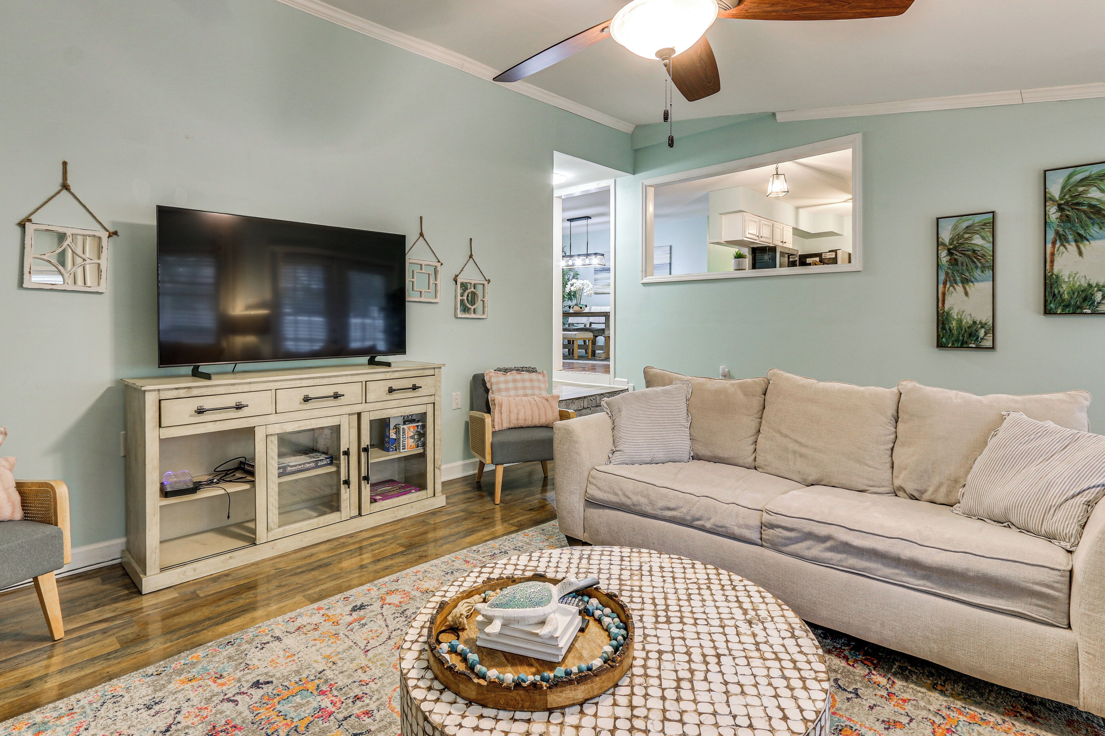 A living room with a television, sofa, and a coffee table with decorative items.
