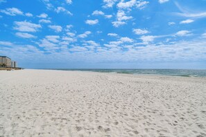 A beach with a building on the left. - Family Friendly & Resort Perks! Perdido Key Condo (Pensacola)