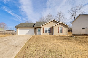 A single-story house with a garage, a front yard, and a small detached garage. - Family Home in Fountain Inn, 2 Mi to Main St! (Fountain Inn)