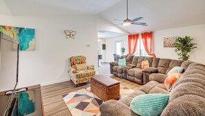 A living room with a sofa, armchair, and ottoman, a ceiling fan, and artwork on the walls. - Family Home in Fountain Inn, 2 Mi to Main St! (Fountain Inn)