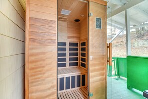 A sauna with a wooden interior, a bench, and a glass door. - Main St Apt w/ Pool Table & Sauna in Westernport! (Westernport)