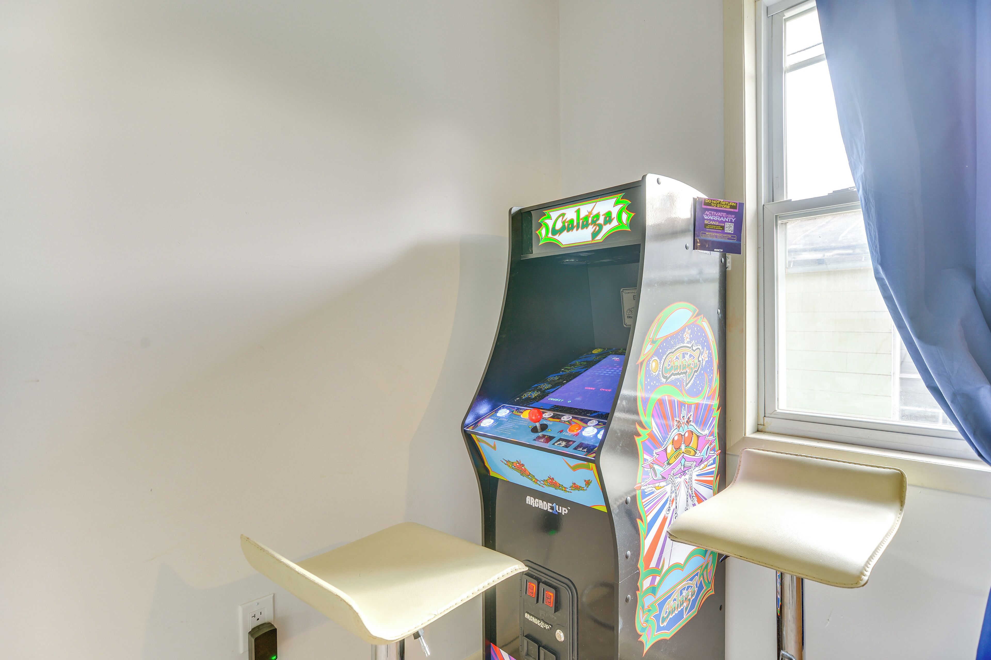 A slot machine with a colorful display and a small table in front of it.
