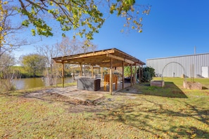 An outdoor patio area with a pergola, seating, and a view of a body of water. - Fishing Dock! 'oarhouse South' Near Venice Marinas (Venice)