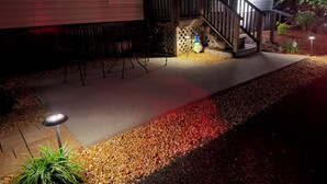A house with a wooden deck, a staircase, and a small garden area with pebbles and plants. - Cozy & quiet 2 bedroom country getaway, close to all the fun! (Elberta)