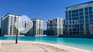 A modern hotel with a pool and clear blue water. - Bloomfields Stu Riviera Skies (Dubai)
