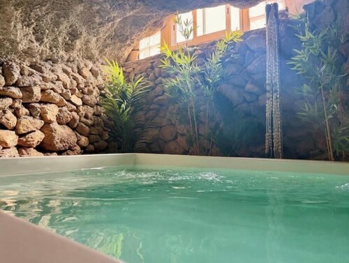 Cave with heated indoor pool and garden