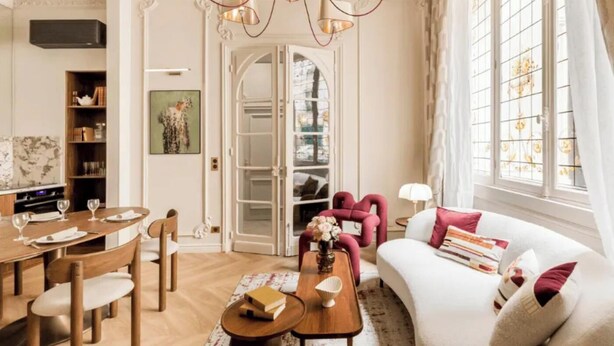 A spacious living room with a dining area, a sofa set, and a chandelier. - JUST MOMENTS FROM THE ICONIC CHAMPS-ÉLYSÉES & AVENUE MONTAIGNE - 2 BEDROOM (Paris)