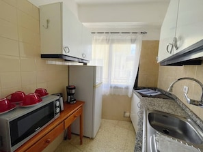 A compact kitchen with a microwave, toaster, and sink. - Sierra - in the center with big balcony (Playa De Los Cristianos)