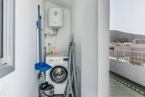 A laundry room with a Bosch washing machine, a water heater, and a blue mop. - Great apartment for 4 people with sea views (Playa De Los Cristianos)