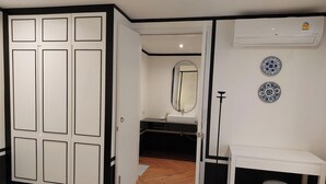 A room with a wardrobe, a mirror, a sink, and decorative plates on the wall. - Wild seaview pool 2bedroom villa 118 (Phuket)