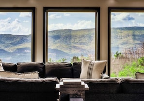 A living room with a large window offering a view of a mountainous landscape. - Private Pool Cabin w/ Theater, Hot Tub & Views (Sevierville)
