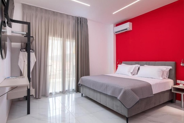 Bright Double Bedroom with Red Accent Wall and Modern Design