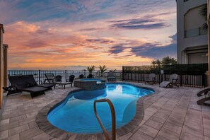 A swimming pool with lounge chairs, a hot tub, and a view of the sunset. - 🌴Luxury Beachfront | Private Pool | Elevator | Stunning Views | Blue Paradise🌴 (Fort Myers Beach)