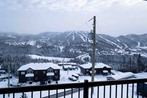 A snow-covered mountain landscape with a ski resort in the background. - Condos Monts-Valin- 213, rue du Massif (Valinouët) (Saint-David-de-Falardeau)