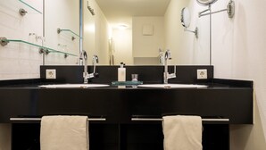 A bathroom with two sinks, mirrors, and glass shelves. - 5-Star Comfort Holiday Home Jümmers: 'Trientje', Prime Location by Wadden Sea National Park (Wangerland-Horumersiel)