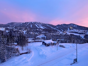 A snow-covered landscape with a small cabin and a ski lift in the background. - Condos Monts-Valin -157, rue du Massif (Valinouët) (Saint-David-de-Falardeau)